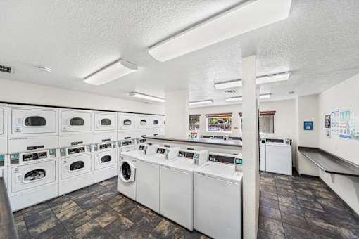 A laundromat with rows of washers and dryers.