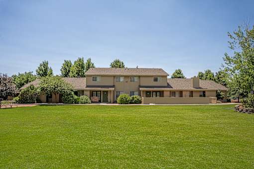 A large house with a lawn in front.