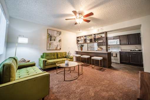 A living room with a green couch and a coffee table.