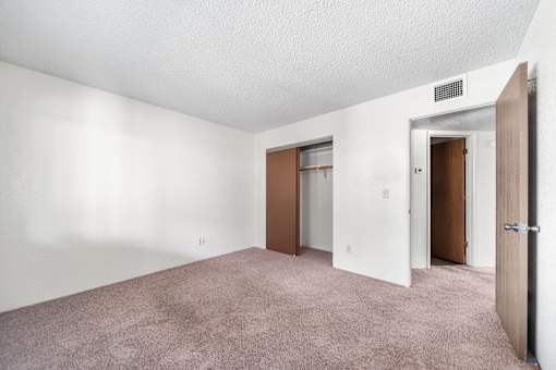 A room with a carpeted floor and white walls.