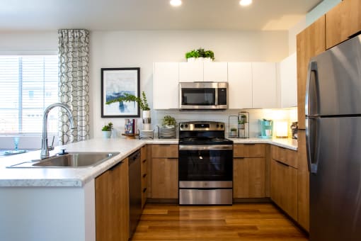 a kitchen with white cabinets and stainless steel appliances