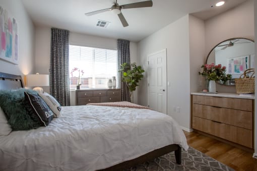 a bedroom with a large bed and dresser