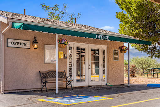 A small office entry with a green awning at Rio Verde Apartments.