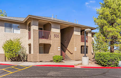 Apartment building number 500 with a parking lot in front.