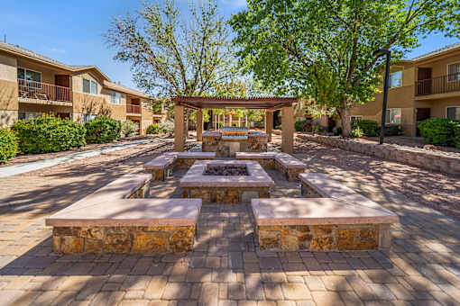 A sunny day at the courtyard with a firepit and BBQ.
