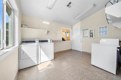 A optional laundry room with a washer and dryer in it.