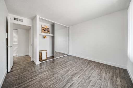A room with a wooden floor and white walls.