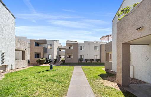 Grass area among the buildings at Desert Springs Apartments.