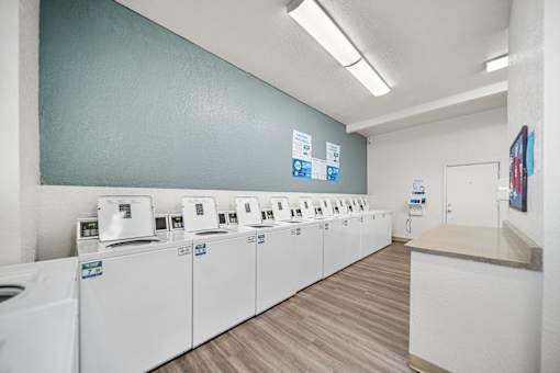 A row of washing machines in the laundry room.