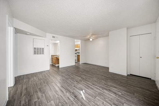 A room with vinyl flooring and white walls.
