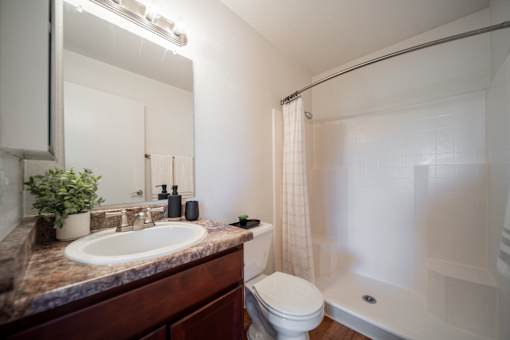 A bathroom with a sink, toilet, and bathtub.