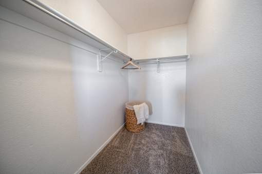 A small room with a basket and a towel hanging on a rail.