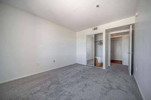 A room with a carpeted floor and white walls.