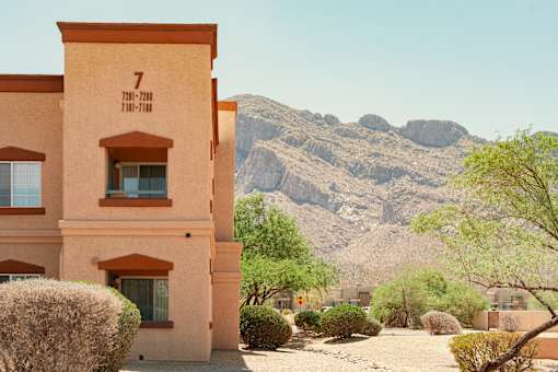 A desert-style building with a mountain in the background.