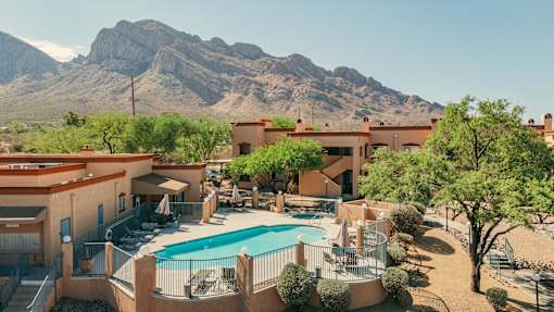 A resort with a pool and a mountain in the background.