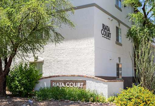 A white building with the words "Riata Court" on it.