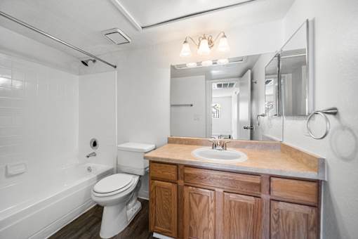 A white toilet sits next to a sink in a bathroom.