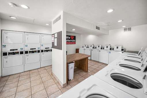 A laundromat with rows of washers and dryers.