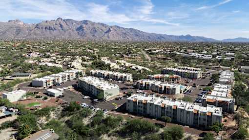 A large housing development in a desert area with mountains in the background.
