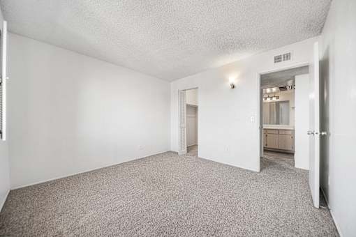 A room with a carpeted floor and white walls.