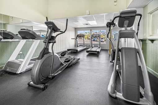 A gym with treadmills and exercise equipment.