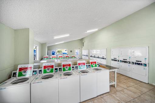 A laundromat with rows of washing machines.