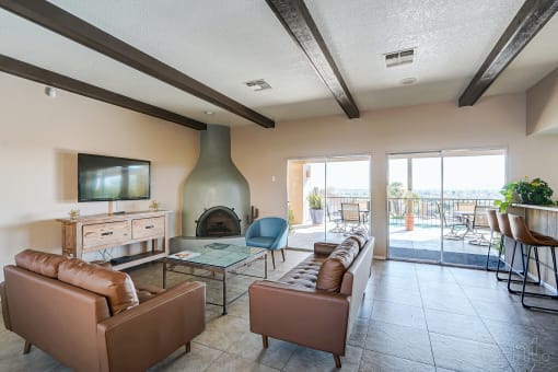 a living room with couches and a television and a fireplace