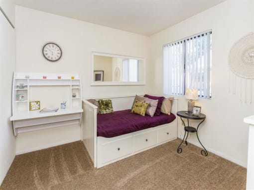 Small Bedroom With Workspace at Woodlands Village Apartments, Flagstaff, AZ