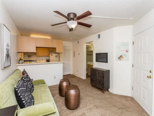 Living Room With Kitchen View at Woodlands Village Apartments, Flagstaff, 86001