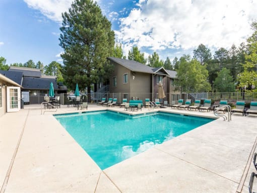 Relaxing Pool Area With Sundeck at Woodlands Village Apartments, Flagstaff, Arizona