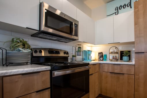 a kitchen with a stove top oven next to a microwave