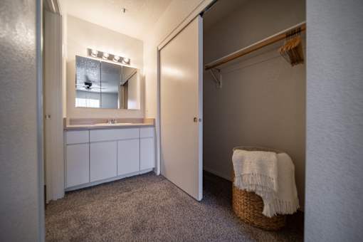 A small room with a white cabinet and a basket on the floor.