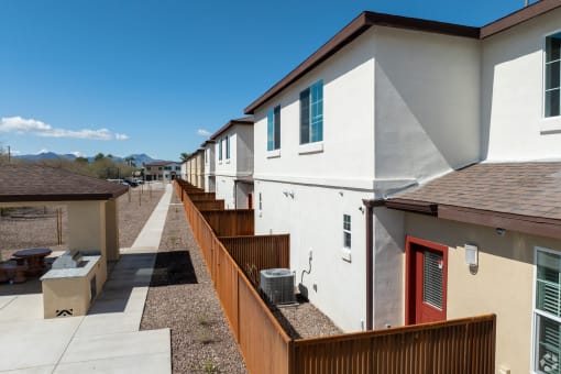 a row of houses with balconies and a sidewalk