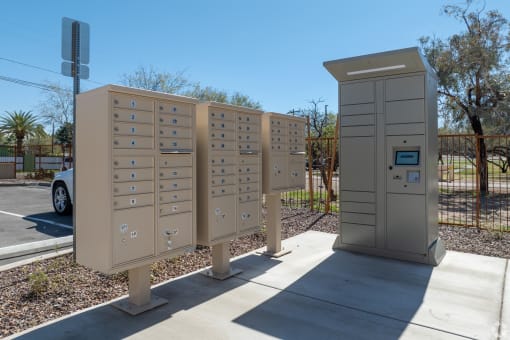 a row of mailboxes are lined up next to a sidewalk