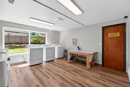 A room with a wooden floor and a brown door.