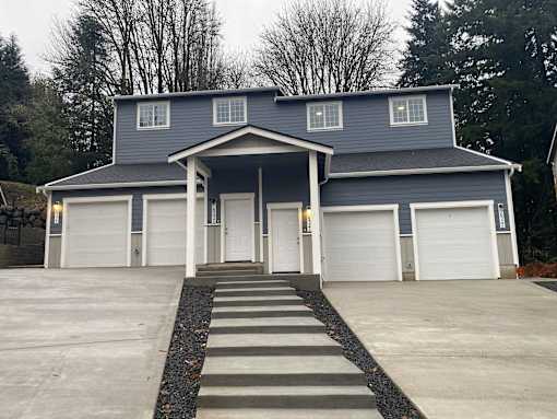 A blue house with white garage doors and a covered entryway.