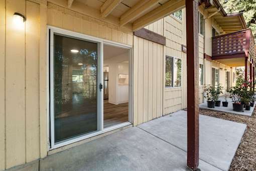 A modern house with a glass door and a brown pillar.