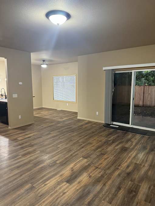 A room with a window and a ceiling fan.