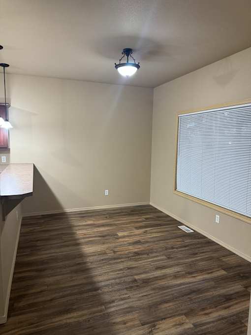 A room with a wooden wall and a light on the ceiling.