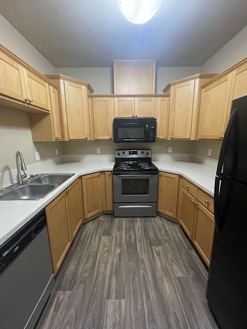 A kitchen area with a microwave and oven built into the cabinetry.