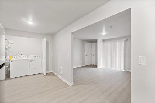 A white kitchen with a washer and dryer.