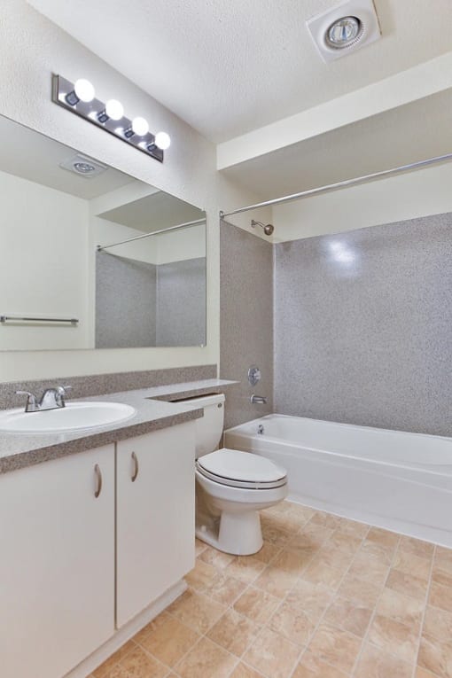 Bathroom with a sink toilet and a bath tub  at Charbonneau Apartments in Seattle, WA 98101