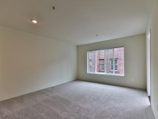 Empty room with a window in it  at Charbonneau Apartments in Seattle, WA 98101