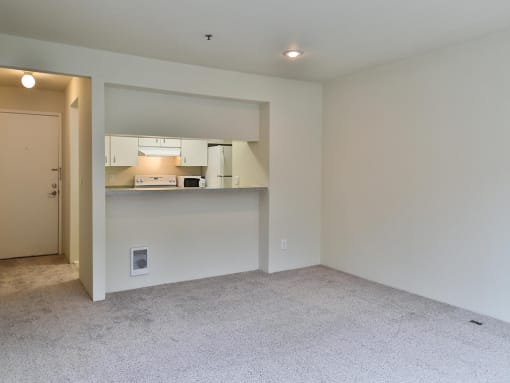 Living room and kitchen  at Charbonneau Apartments in Seattle, WA 98101