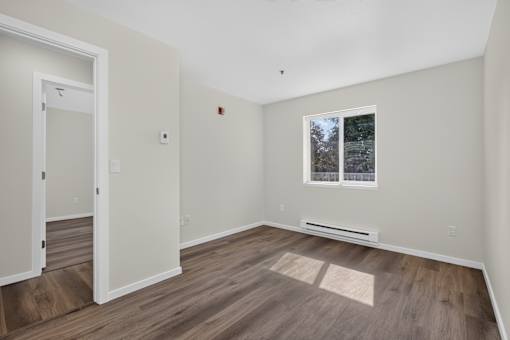 A room with a window and a door.