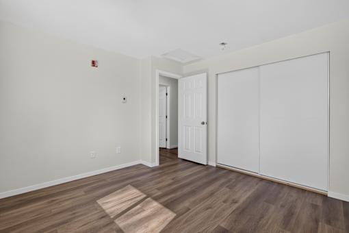A room with a white door and a white cabinet.