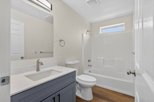 A bathroom with a white toilet and a white sink.