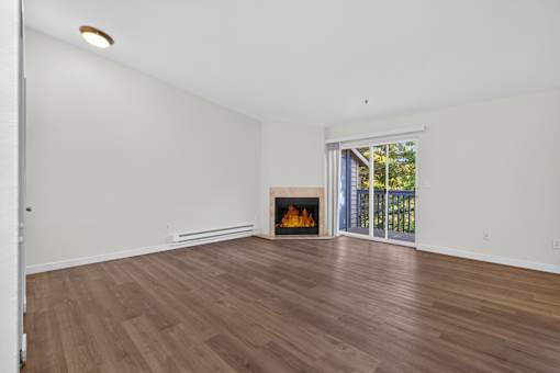 A room with a fireplace and sliding glass doors.