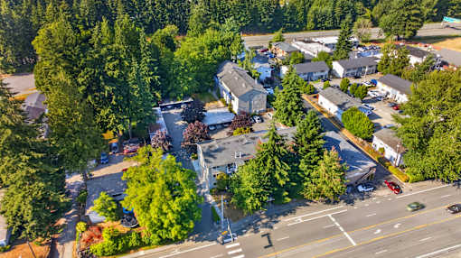 A road with cars and trees on the side.