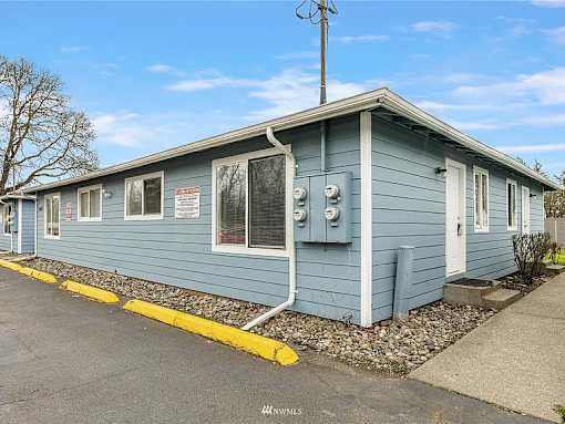 A blue building with a yellow line in front.